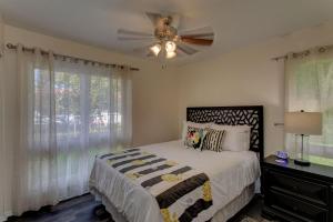 a bedroom with a bed and a ceiling fan at Hilo Hale Kaumana in Hilo