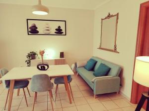 a living room with a table and a chair at Andy's in Assemini
