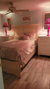 a bedroom with a bed with two night stands and two lamps at 210 Worchester St #405 in Ocean City +22 photos