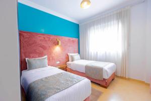 Postel nebo postele na pokoji v ubytování Moroccan Floors - Suites Appart-Hôtel