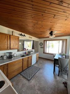 a kitchen with a wooden ceiling and a table at Brookside Retreat, LLC in Newaygo