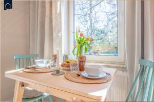 a dining room table with a table set with food and candles at Green Village Igelnest in Benz