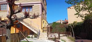 a house with stairs leading up to a building at El Guardaviñas, entre Montes y Viñedos in Ábalos