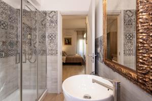 a bathroom with a tub and a sink and a shower at Mondello House Eraclea in Mondello +71 photos