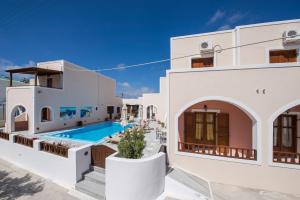 a villa with a swimming pool in a resort at Villa Voula in Perissa