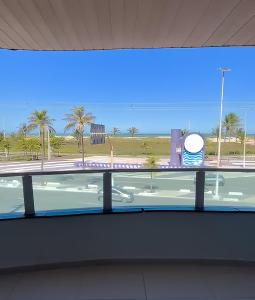 a window in a building with a view of a beach at HANNA Arcos d'Atalaia Hotel - Aracaju in Aracaju