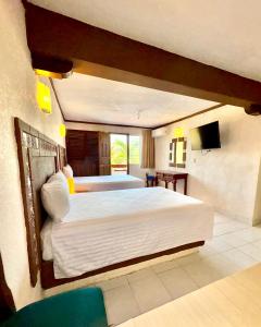 Ένα ή περισσότερα κρεβάτια σε δωμάτιο στο Suites Cancun Center