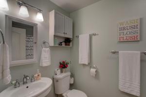 a bathroom with a sink and a toilet and a mirror at Fern Forest Hale in Volcano +29 photos