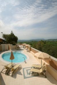 a swimming pool with two chairs and an umbrella at Casa Oliva borgo del Benessere Olistico in Bargni