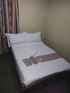 Postel nebo postele na pokoji v ubytování kapok city hotel