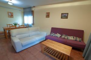 a living room with a couch and a table at Alojamientos Poseidon in Robledillo de la Jara