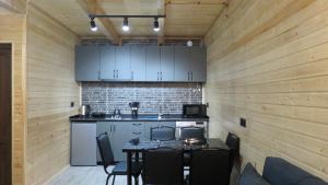 a kitchen with a table and chairs in a room at Cottage nikolozi2 in Arsha