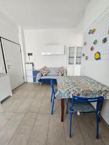 a dining room with a table and a bench at Il Balcone sul Conero in Marcelli