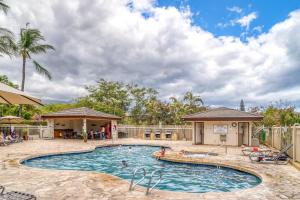 a pool at a resort with people in it at Maui Banyan H506 in Wailea