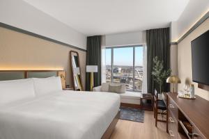 a hotel room with a bed and a desk at The Printing House Hotel, Tapestry Collection By Hilton in Nashville +65 photos