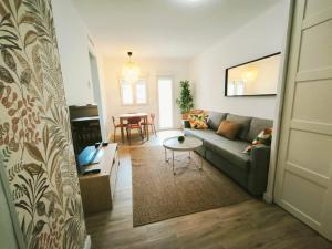 a living room with a couch and a table at Apartamento Puerta de Madrid 2 in Alcalá de Henares