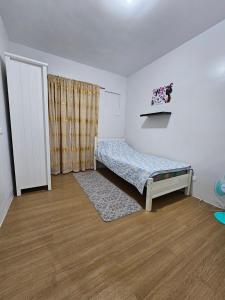 a small bedroom with a bed and a window at Pine suite Condo Tagaytay in Tagaytay +23 photos
