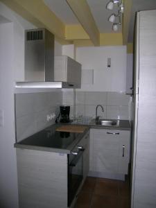 a kitchen with a sink and a counter top at Ti Gwen in Plonévez-du-Faou