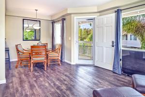 a dining room with a table and chairs and a porch at Ko Olina Fairways #4E in Kapolei +24 photos