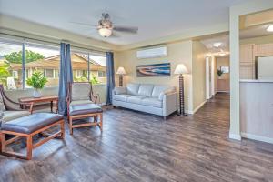 a living room with a couch and a table at Ko Olina Fairways #4E in Kapolei