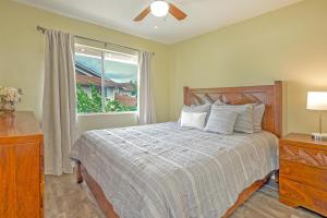 a bedroom with a bed and a window at Ko Olina Fairways #4E in Kapolei