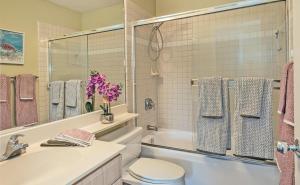 a bathroom with a sink and a toilet and a tub at Ko Olina Fairways #4E in Kapolei