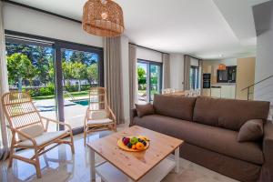 a living room with a couch and a table with a bowl of fruit at Villa Casa LUZ in Bodrum City