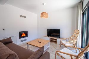 a living room with a couch and a fireplace at Villa Casa LUZ in Bodrum City