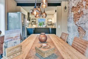 a kitchen and dining room with a wooden table at BETTer Be here in Kellinghusen
