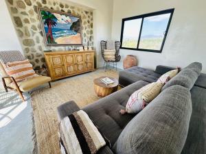 a living room with a couch and a table at Casa Asombro - 3-bed villa in Pueblo Pescadero in El Pescadero