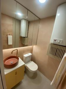 a small bathroom with a toilet and a sink at Museuflat in Póvoa de Varzim +31 photos