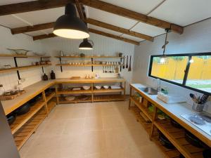 a kitchen with wooden shelves and a large window at Casa de Campo para desconectarse de la ciudad in Rancagua