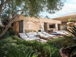 a patio with white couches and trees and bushes at The Palazzo at The Venetian® in Las Vegas
