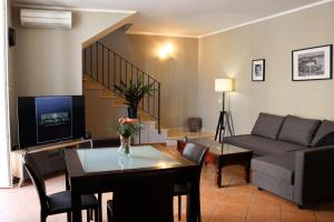 a living room with a couch and a table at All'Ombra Della Reggia in Caserta
