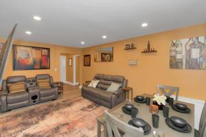 a living room with couches and a table at Spacious 3BR Condo in DTWN in Atlanta