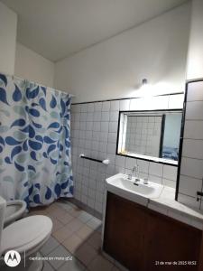 a bathroom with a sink and a toilet and a window at Urbano B&B 2A in San Juan