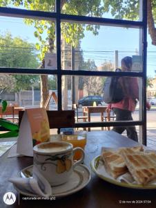 a table with a cup of coffee and a plate of toast at Urbano B&B 2A in San Juan