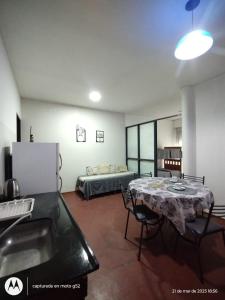 a living room with a table and a bed at Urbano B&B 2A in San Juan