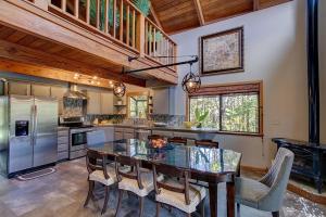 a kitchen with a table and chairs and a refrigerator at Halehikiola in Volcano