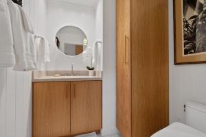 a bathroom with a sink and a mirror at Coconut Hut in Kilauea +37 photos