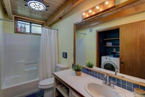 a bathroom with a sink and a washing machine at Halehikiola in Volcano +25 photos