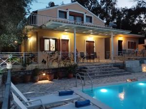 a house with a swimming pool in front of it at Villa Milou in Kagkátika +66 photos
