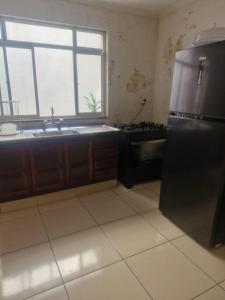 a kitchen with a stainless steel refrigerator and a window at Aurora um in Guarulhos