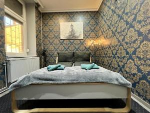 a bedroom with a bed with two pillows on it at JohnGold Buddha Room in Debrecen