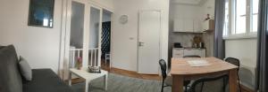 a living room with a table and a kitchen at Vuk 1 in Belgrade