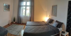 a bedroom with a bed and a couch and a window at Vuk 1 in Belgrade