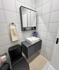 a white bathroom with a sink and a mirror at Canoas/RS-Linda Casa 3 qtos 8P próx ULBRA / REFAP in Canoas +50 photos