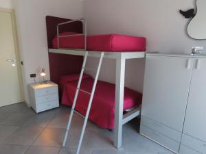 a bedroom with a bunk bed with a red pillow at L'attico Rinascente in Signa