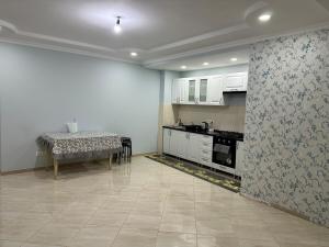 a kitchen with a table and a counter top at Fine Sleep & Fly in Chişinău
