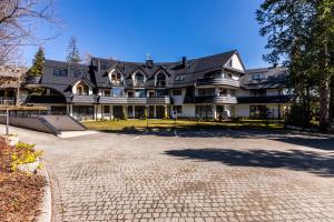 a large house with a skateboard in front of it at Apartament Atena in Zakopane